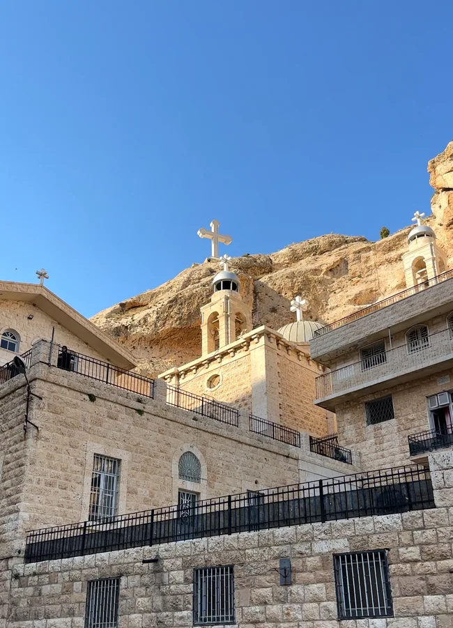 Real image of Maaloula Saint Thecla monastery beneath its limestone cliffs