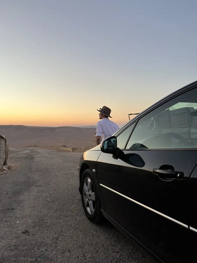 Ziyara Ride guide standing beside the private vehicle